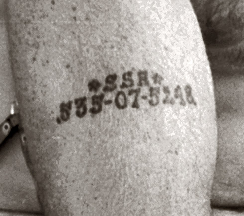 Note Social Security number tattooed on his arm.