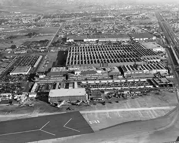 A before photo of Lockheed during WWII (unbelievable 1940s pictures). This is pretty neat special effects during the 1940's. I have never seen these pictures or knew that we had gone this far to protect ourselves. During World War II the Army Corps of Engineers needed to hide the Lockheed Burbank Aircraft Plant to protect it from Japanese air attack. They covered it with camouflage netting to make it look like a rural subdivision from the air.  (Besides everything else, check out the cars.)

Cars hidden below tarp
Hidden from above
Parking lot hidden from below


