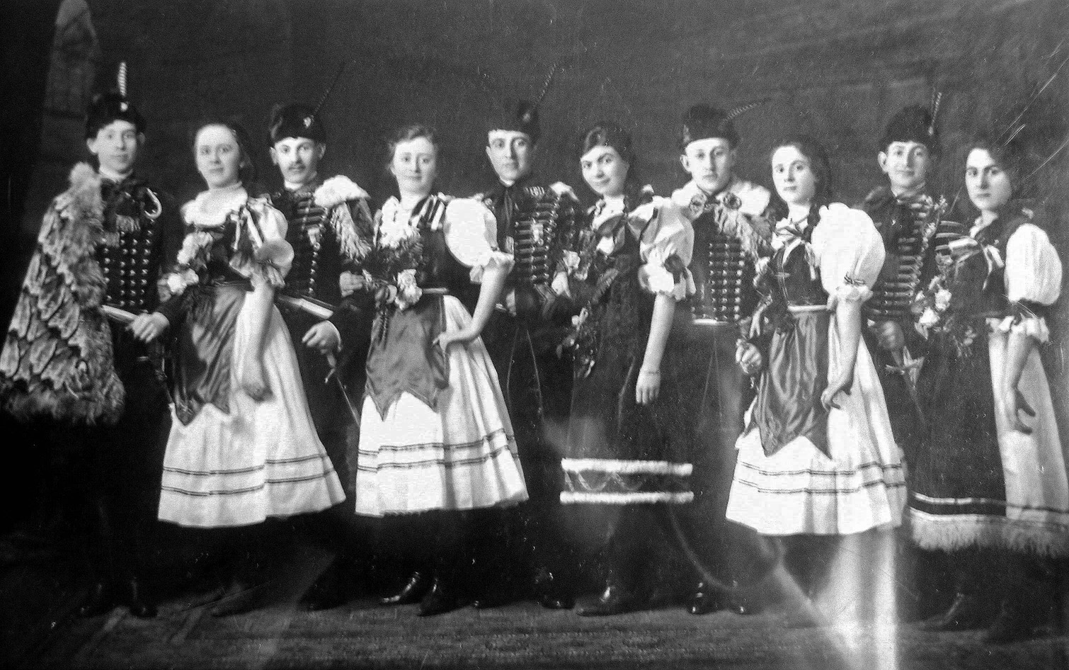 My paternal grandfather's family (three brothers, three sisters) emigrated from Hungary about the turn of the century and settled in the predominantly Hungarian-Jewish Logan section of Philadelphia. Some of them were photographed at some sort of costume event.  

I think that males number 1, 2, 3 and 5 from the left were my grandfather Nelson Blass (1884-1952), uncle Eugene Blass (1890-1953), uncle Rudy Polya (1889-1987) and uncle Armin Braun (1890-1957). The only female whom I recognize is [middle] aunt Sara Blass Polya (1888-1973).  View full size.

