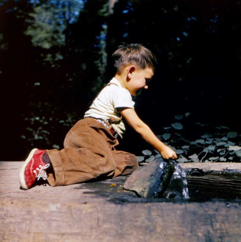 Me with red sneakers (a trademark to this day), circa 1951. This is on a trailer vacation to Northern California from Los Angeles and anything that involved water had my full attention and participation. View full size.

