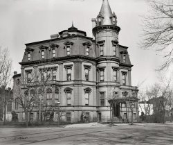 Washington circa 1900. "Stewart's Castle, Dupont Circle." The William Morris Stewart house on Massachusetts Avenue, designed by Adolph Cluss, shortly before it was demolished. National Photo glass negative. View full size.
Stewart&#039;s CastleStewart’s Castle at 1913 Massachusetts Avenue was built in 1873 for California [actually Nevada] Senator William Morris Stewart, who made his fortune in gold mining. Despite architect Adolph Cluss's intentions to imitate the wealth and glamour of European nobility, the castle proved to be too much of a financial burden and was leased to the Chinese government from 1886 to 1893. The house was sold to Senator William A. Clark from Montana, who demolished it with the intention of building a new residence; however, the land remained vacant until he sold it in 1921, and a bank was subsequently erected on the site.
&nbsp; &nbsp; &nbsp; &nbsp; &nbsp; &nbsp; &nbsp; &nbsp; -- Washington Places (University of Virginia)
BurnedAccording to the New York Times of December 31, 1879, the house burned down.
[The NYT article seems a bit confused. Iowa Circle (now called Logan Circle) was six blocks east of the Stewart house, which was on Dupont Circle at Massachusetts and Connecticut avenues. The residence, built in 1873, did indeed catch fire on the evening of December 30, 1879, but only the top floor was destroyed. - Dave]
Say it ain&#039;t so!Why was this beautiful creation destroyed so soon?  It is one of the finer examples of architecture you'll ever see.  Does anyone know the story?
Builded with Brick

Builded With Brick
Castle Stewart Being Restored
to More Than Original Splendor

Castle Stewart, built by the former Senator of that name from Nevada, on Dupont circle, when that now fine neighborhood was in its infancy, and burned some three years since, is being remodeled.  The exterior will resume the imposing appearance possessed before the flames destroyed the upper story altogether, and ruined the plaster and woodwork of the interior. Mr. Robert I Fleming, the architect and builder, has the work in hand, and will make the restored mansion much handsomer that it ever was, and, what is more important, not liable to burn on such slight provocation, at least.  The work, which is estimated to cost $25,000, is being done by Mrs. Stewart.  In addition to the restoration, three dressing rooms, to be used in connection with the stage when private theatricals are to be given, are being erected; also a conservatory and a balcony on the Connecticut avenue front.

Washington Post, Jan 18, 1883 


Where&#039;s Herman?I keep thinking if I look at the photo long enough, I'll see Herman, Lily, Eddie, Grandpa or another member of the Munster family show up at one of the windows. If I'm really lucky, Gomez and Morticia Addams might be there for a visit as well. 
(The Gallery, D.C., Natl Photo)