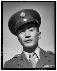 Corporal Jimmie Shohara, visiting his parents at the Manzanar Relocation Center in 1943. View full size. Photograph by Ansel Adams.
