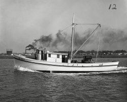 The 'Jane Carlyn' is shown here freshly launched and leaving the Diesel Engine Sales Co. docks in St. Augustine, Florida. Roland Styron stands at the bow of his brand new 65' wooden shrimp boat. Capt. Styron had a fish house in Hobucken, N.C. beside the R.O. Mayo fish house and later operated a fleet of shrimp boats that travelled as far south as the Florida Keys. Diesel Engine Sales Co. (DESCO) was a the leading builder of shrimp boats in the US and built 2272 wooden fishing vessels between 1943 and 1982. Photo taken in 1944. View full size.
The CarMy guess is he drove his car down to St. Augustine, FL from North Carolina to pick up his boat and now he is taking his car and shiny new boat back home to NC.
(ShorpyBlog, Member Gallery)