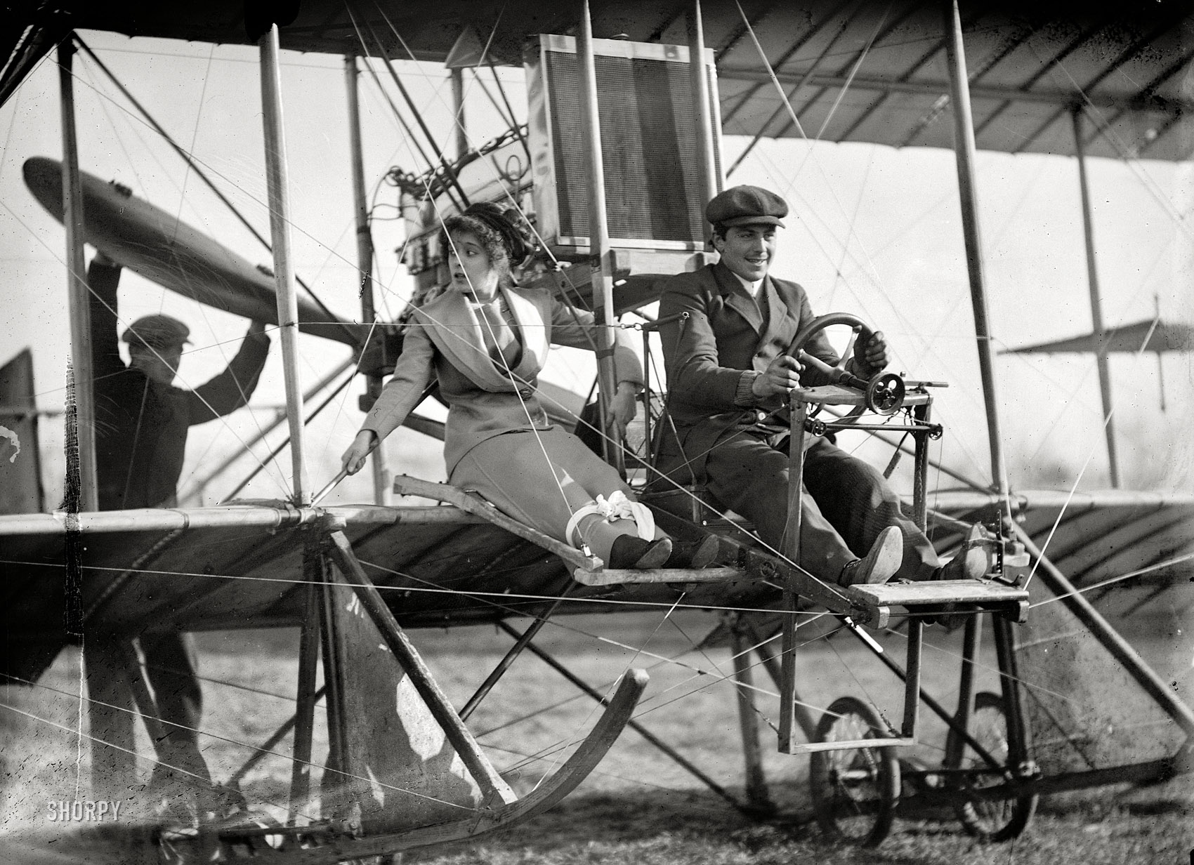 Washington, D.C., or vicinity circa 1911. "Senorita Lenore Riviero with Antony Jannus in Rex Smith aeroplane." Please fasten your seatbelts (or skirts) while we prepare for departure. Tony Jannus, the pioneering but short-lived Washington aviator, a few years before his final flight landed him somewhere at the bottom of the Black Sea. Harris & Ewing Collection glass negative. View full size.