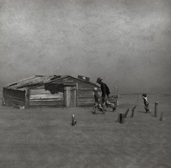 April 1936. "Farmer and sons walking in the face of a dust storm. Cimarron County, Oklahoma." Perhaps Arthur Rothstein's best known Dust Bowl image, and overall one of  most memorable photographs to come out of the entire FSA/OWI program. Gelatin silver print by Arthur Rothstein. View full size. 