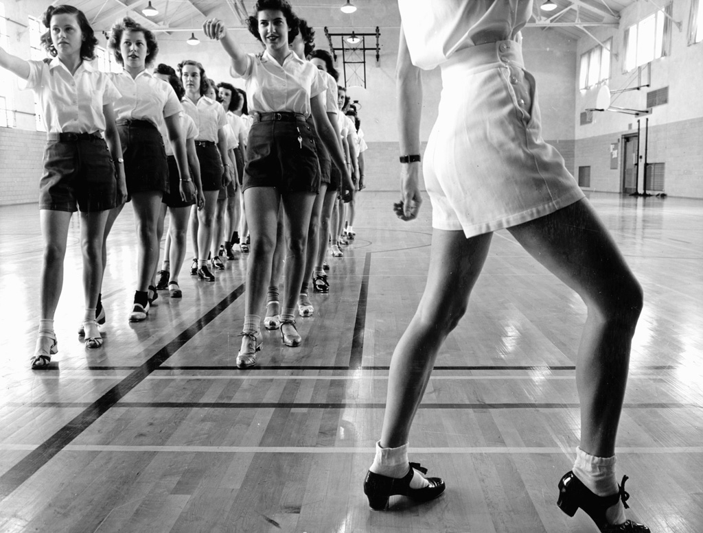 A tap dancing class in the gymnasium at Iowa State College in Ames, Iowa. Photo by Jack Delano, 1942. View full size.