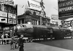 Promotional event for the film "Desert Rats." Taken on Times Square in New York City on May 10, 1953 by Peter Jingeleski. View full size.
Famous fuselageLucky Lady II flew nonstop around the world in 1949
https://en.wikipedia.org/wiki/Lucky_Lady_II
(ShorpyBlog, Member Gallery)
