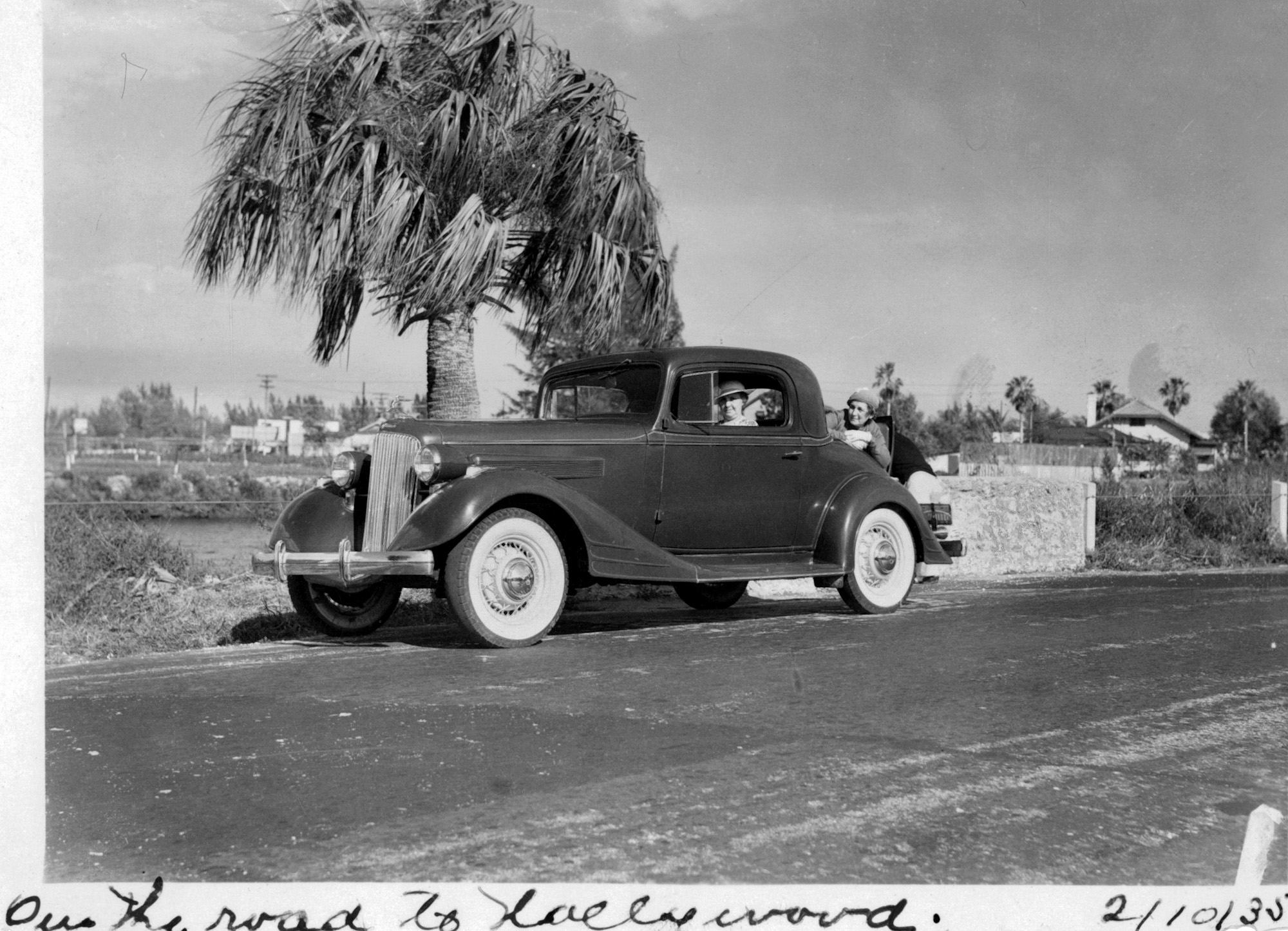This photo was scanned from a print that my sister has in the family photo collection. The hood ornament, as unclear as it is, looks like a Buick one from 1934-1935 but I can't match the car with any I've seen, particularly the grill and trim on the side of the hood. We think the driver is our Grandmother but don't remember any family stories of a trip west (from Missouri) in 1935. View full size.