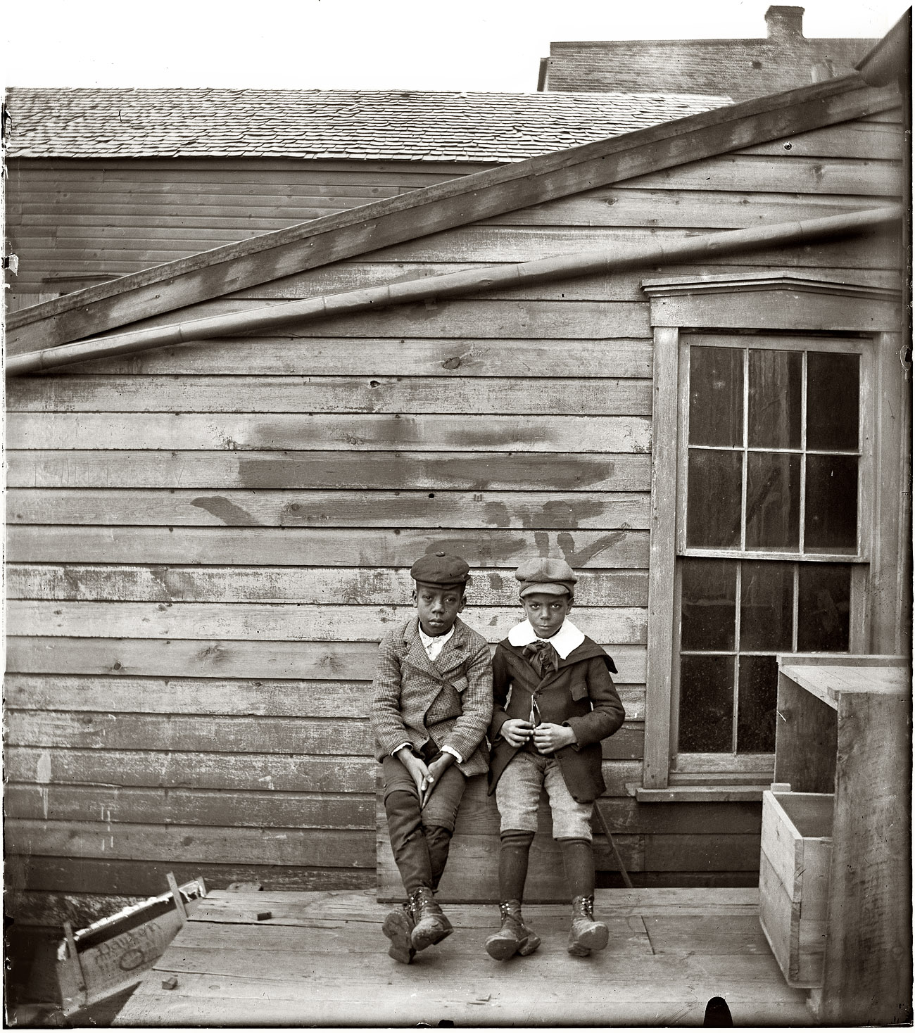 Clarence "Grandpa" Liv and Alonzo "Teddy" Tucker behind the Wright Cycle Company on West Third Street in Dayton, Ohio, circa 1897-1901. 4x5 dry-plate glass negative by Wilbur and/or Orville Wright. View full size.

