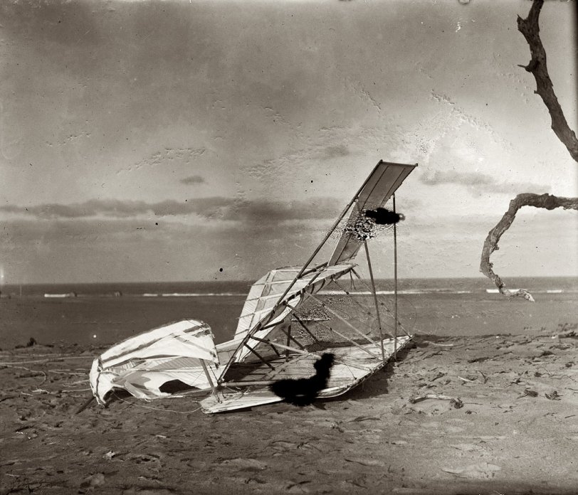 A crumpled glider destroyed by the wind on Hill of the Wreck in Kitty Hawk, North Carolina. The hill was named after a shipwreck, not the fate of the glider. Photograph by either Orville or Wilbur Wright, Oct. 10, 1900. View full size.
