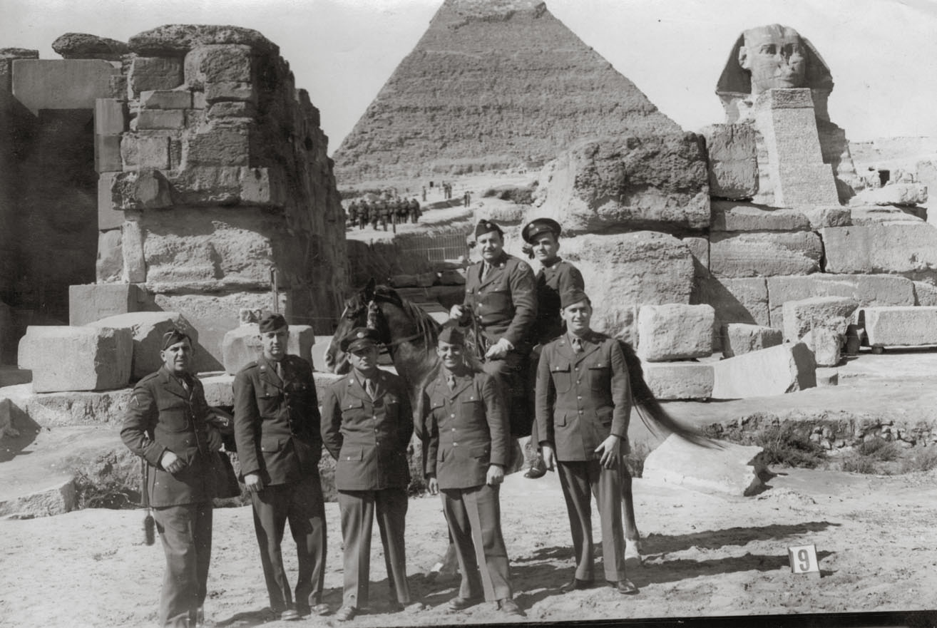 The gentleman on the front row, far right, is my grandfather, Sgt. Louis Peter.  He served in the U.S. Army Air Forces during World War II, and spent six months in Egypt in 1945.  Here he is with his comrades in Cairo at the Great Pyramids of Giza and the Sphinx.  Unfortunately, I have no names to identify the other men. View full size.
