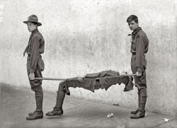 "Boy Scout training demonstration, 1912." Washington, D.C. Our fourth look at Scout first aid, this one showing a litter made using two poles and some clothing. Harris & Ewing Collection glass negative, Library of Congress. View full size.