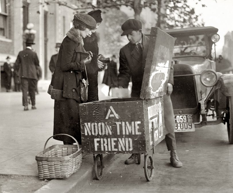 Washington, D.C., circa 1919. "Lunch cars. One of the greatest foes of the H.C. of L. [High Cost of Living] in Washington has been the lunch wagons selling 20 cent box lunch, which is very popular with the Department clerks. A concerted effort has been made by the lunch room keepers to keep them off the street but so far without success." On the box: "Leoffler's Liberty Lunch 20¢" 4x5 inch glass negative, National Photo Company Collection. View full size.
