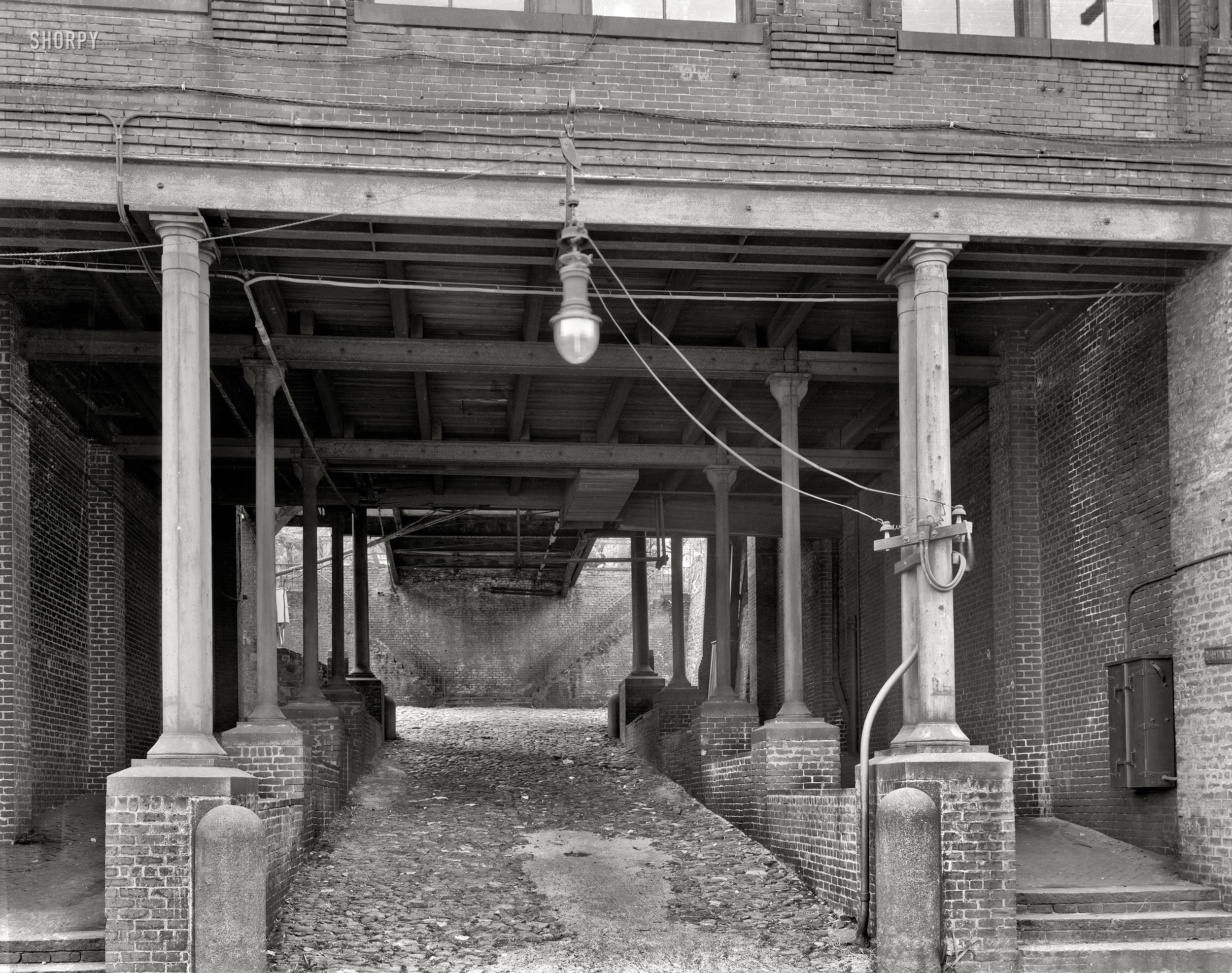 Chatham County, Georgia, circa 1937. "Stoddard's Lower Range from Factory [Factors] Walk, River Street, Savannah." Passage through the cotton warehouses built by John Stoddard on the bluffs above the Savannah River in the late 1850s. 8x10 inch safety negative by Frances Benjamin Johnston. View full size.