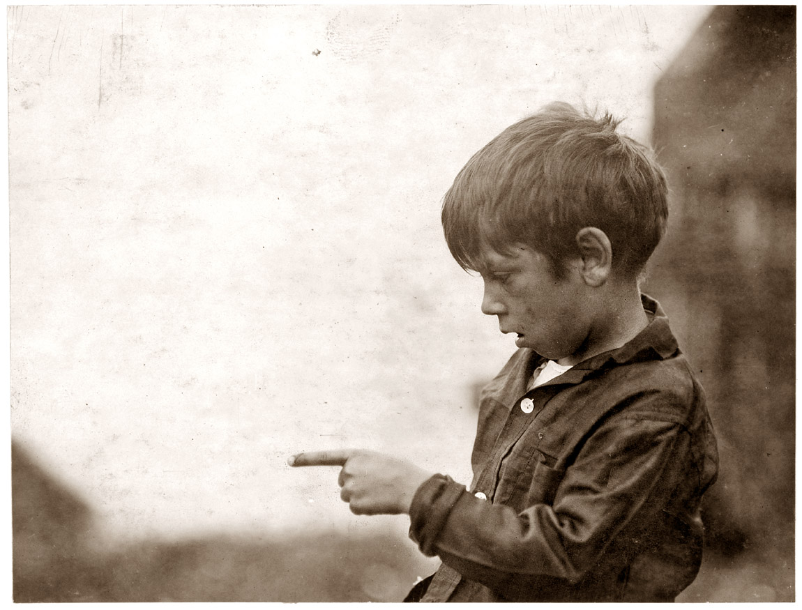 "I cut my finger nearly off, cutting sardines the other day." Seven-year-old Byron Hamilton of Eastport, Maine, earns 25 cents a day as a cutter at the Seacoast Sardine cannery. August 1911.  View full size. Photo by Lewis Wickes Hine.