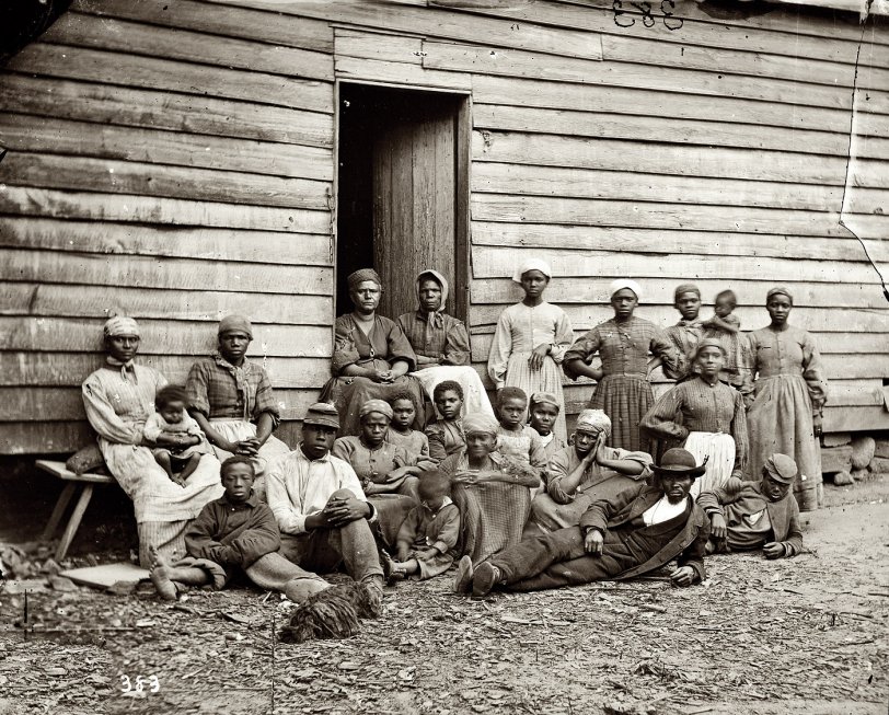 May 14, 1862. Cumberland Landing, Virginia. "Group of contrabands [runaway slaves] at Foller's house." Photographs from the main Eastern theater of war: The Peninsular Campaign, May-August 1862. Wet-plate glass negative, half of stereograph pair. View full size. Photograph by James F. Gibson (b. 1828).
