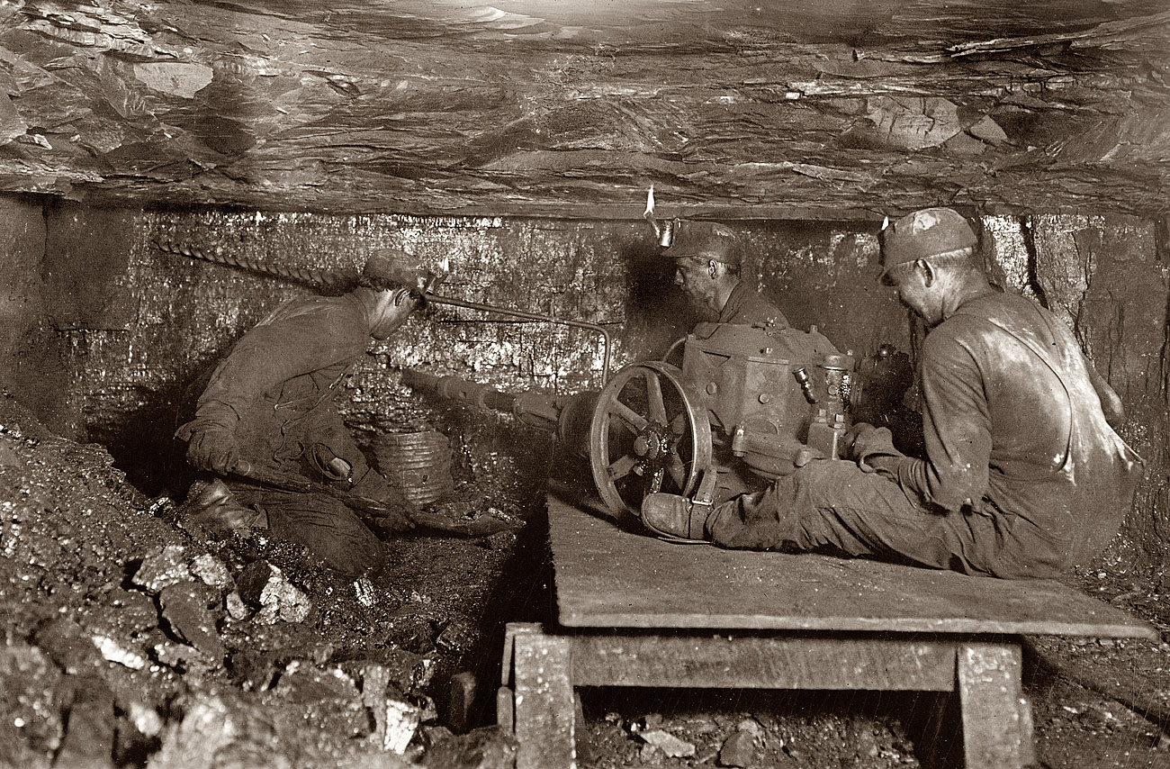 October 1908. Digging coal by machinery at the Brown Mine in West Virginia. Note open-flame headlamps. View full size. Photograph by Lewis Wickes Hine.