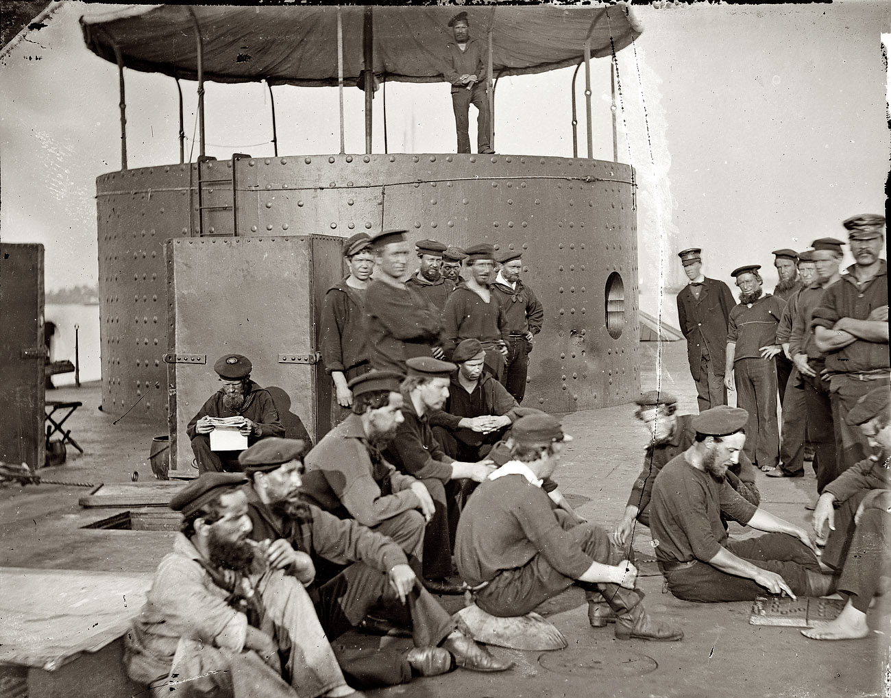 July 9, 1862. "James River, Virginia. Sailors relaxing on deck of the U.S.S. Monitor." From photographs of the Federal Navy and seaborne expeditions against the Atlantic Coast of the Confederacy, 1861-1865. View full size. Wet plate negative, left half of stereograph pair. Photograph by James F. Gibson.