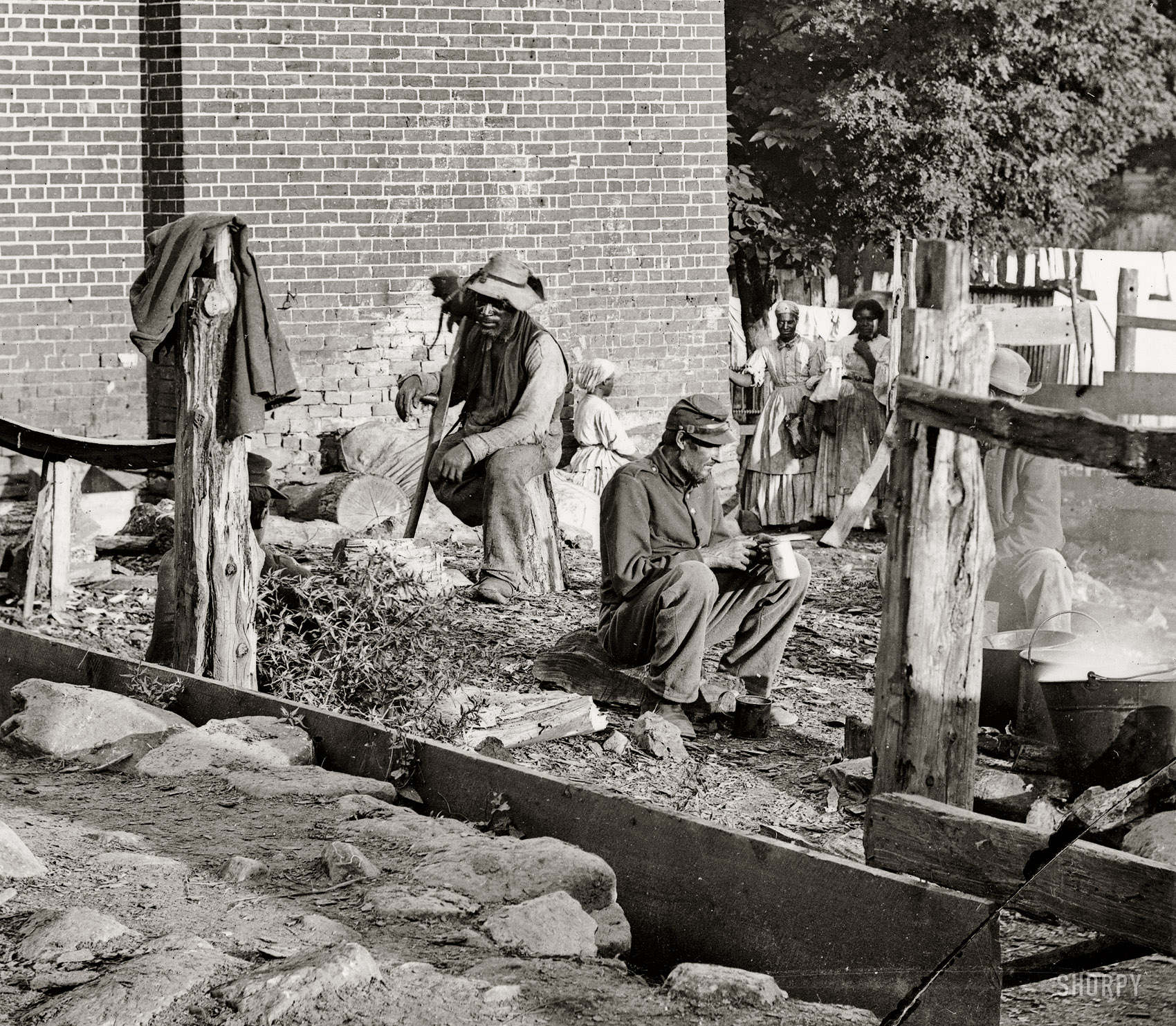August 1862. "Culpeper Court House, Virginia. Federal soldiers and wounded Negro." Wet-plate glass negative by Timothy H. O'Sullivan. View full size.