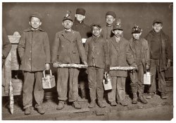 December 1910 or January 1911. At the close of the day, just up from the shaft at the Pennsylvania Coal Company's South Pittston mine. Smallest boy, next to right hand end, is a nipper. On his right is Arthur, a driver. Joe on Arthur's right is a nipper. Frank, boy at left, is a nipper, works a mile underground from the shaft, which is 5000 feet down. View full size. Photograph by Lewis Wickes Hine.