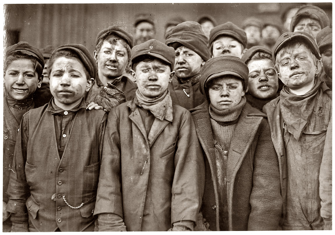 January 1911. Breaker boys in #9 Breaker, Pennsylvania Coal Company mine at Hughestown Borough near Pittston. Smallest boy is Angelo Ross, 142 Panama Street, Hughestown Borough. View full size. Photograph by Lewis Wickes Hine.