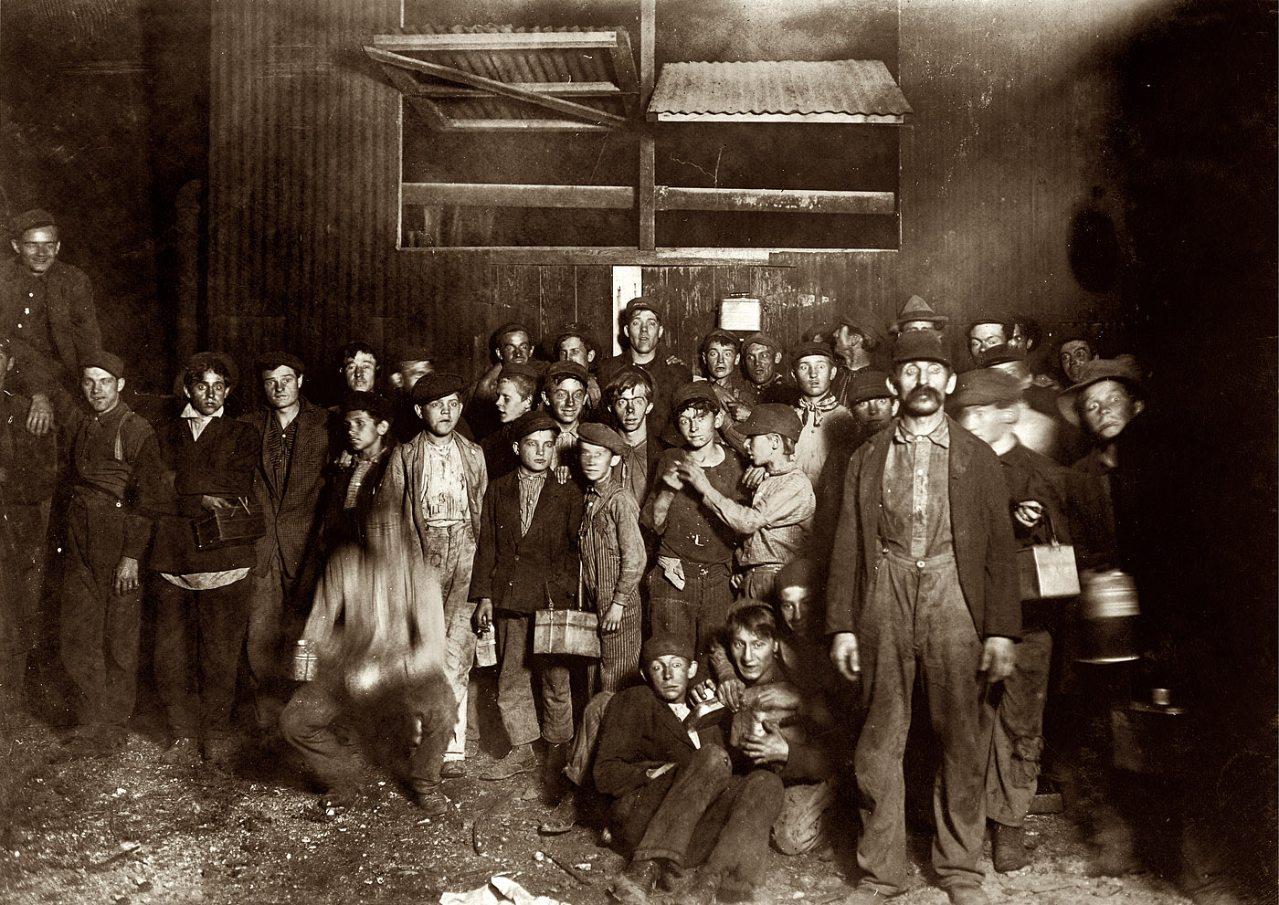 August 1908. "Night Shift Leaving for Home. Indiana Glass Works, 8 a.m." Photograph and caption by Lewis Wickes Hine. View full size.