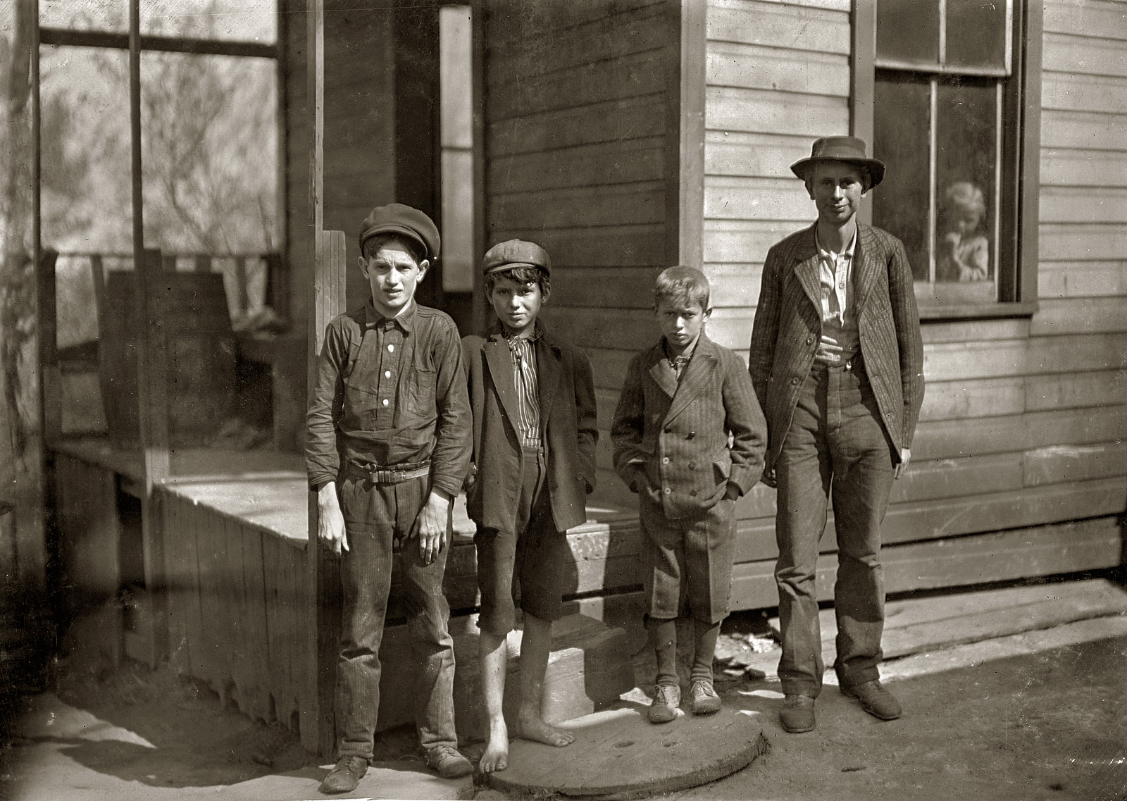 October 1908. Fairmont, West Virginia. "These boys (and one other small one) and their father work in Monongah Glass Works. Father gets $1.75 a day, one boy $1.25 a day, four get 80 cents. Total $6.20 a day. Live in a tumble-down house. What is the trouble?" Photo and caption by Lewis Wickes Hine. View full size.