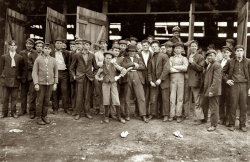 Workers at the More-Jones Glass Co. in Bridgeton, N.J. Small boy in the middle is Harry Simpkins. The photograph is by Lewis Wickes Hine, who described the work conditions as, "dirty, noisome." November 1909. View full size.
(The Gallery, Kids, Lewis Hine)