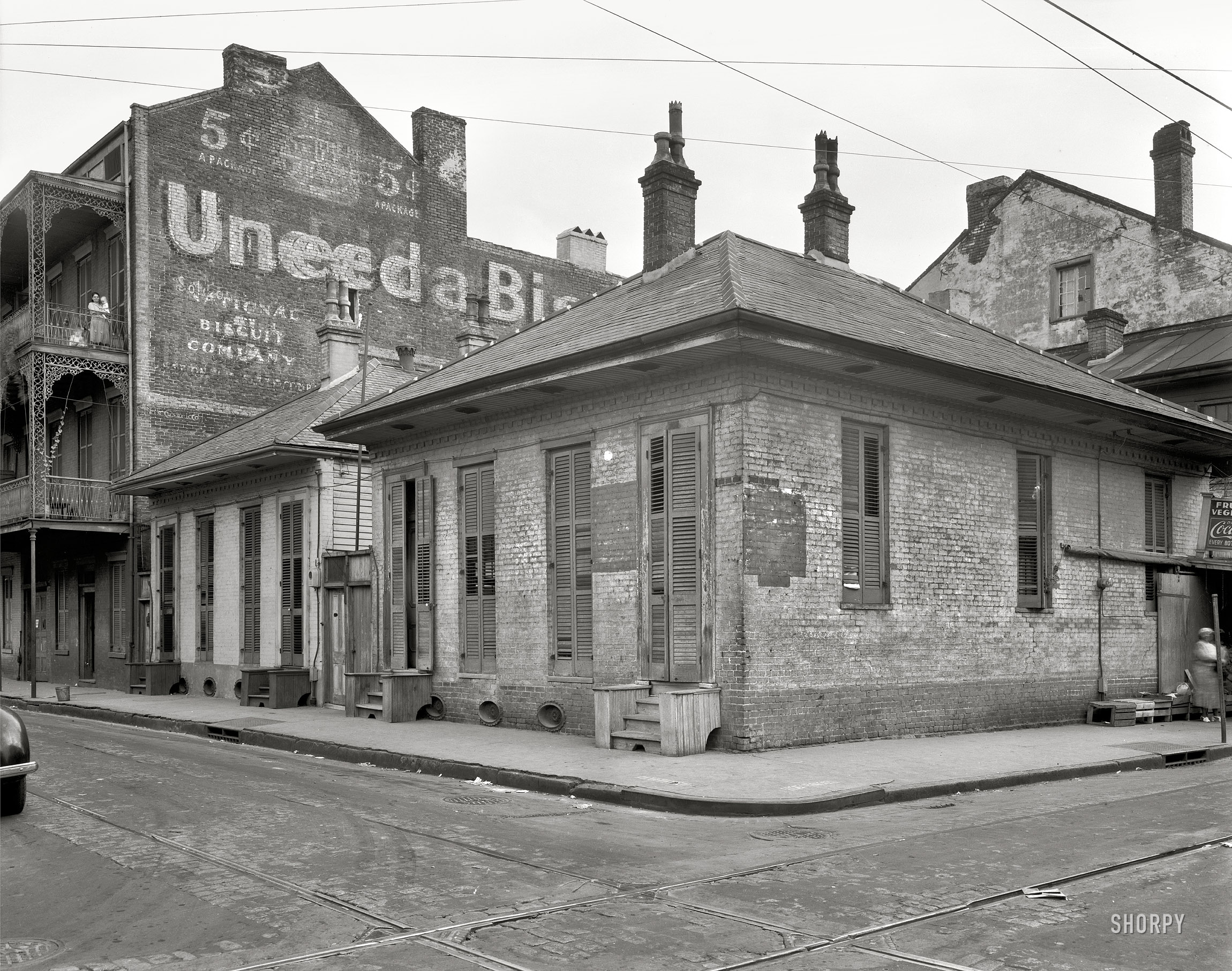 New Orleans circa 1937. "Dumaine Street at Bourbon." Momma's balcony scene. 8x10 inch safety negative by Frances Benjamin Johnston. View full size.