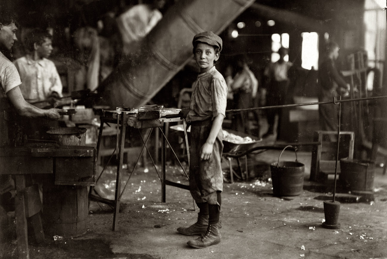 June 1911."Carrying-in" boy in Alexandria Glass Factory, Alexandria, Virginia. Works on day shift one week and night shift next week. Photograph and caption by Lewis Wickes Hine. View full size.