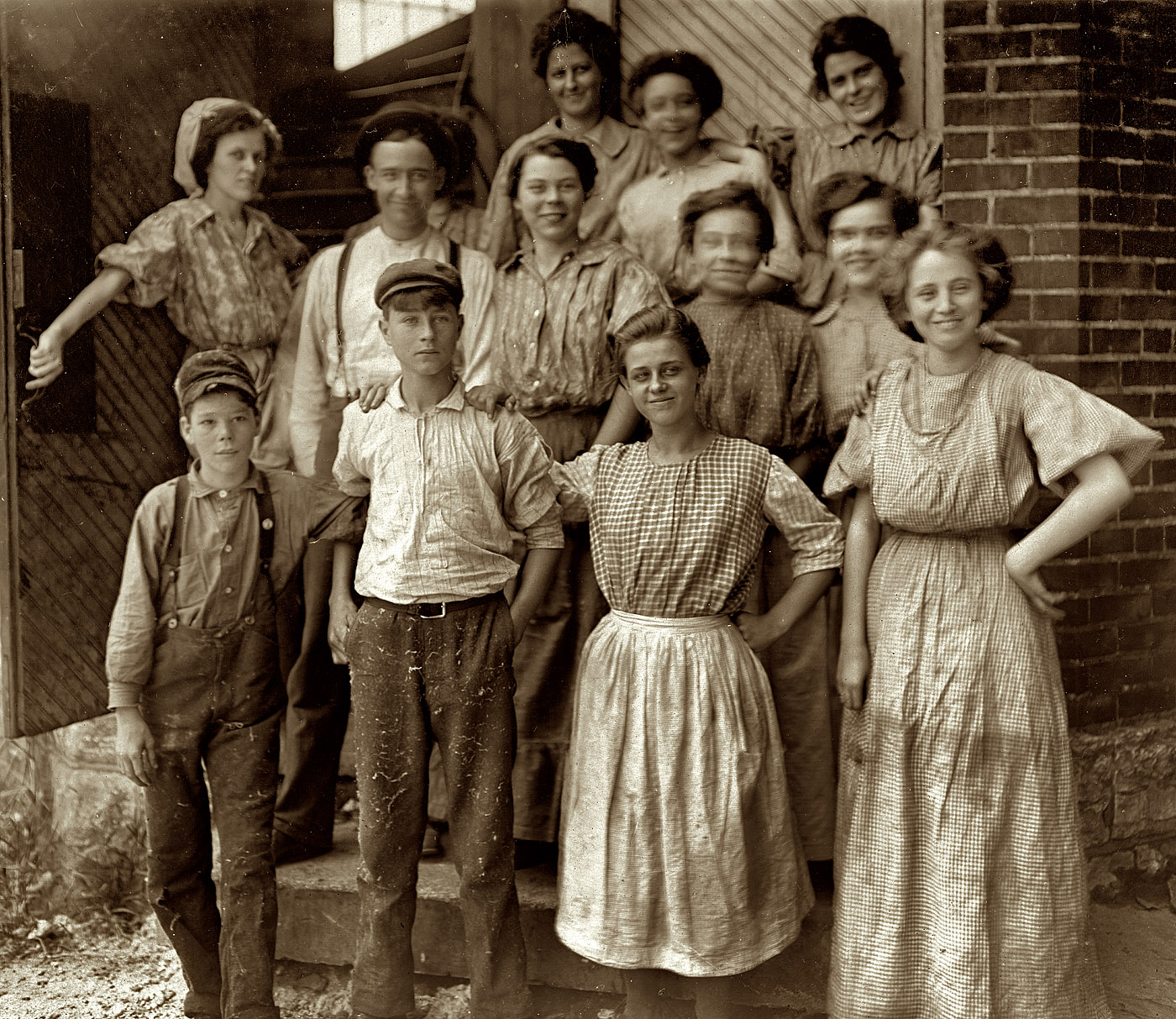 Noon, August 1908. "Young People in an Indianapolis Cotton Mill." Uncharacteristically happy photograph by Lewis Wickes Hine, who generally seemed to prefer that his subjects scowl for the camera. View full size.