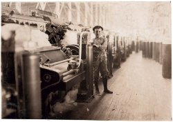 October 1908. "Boy Sweeper and Carding Machines, Lincoln Cotton Mills, Evansville, Indiana." Photograph by Lewis Wickes Hine. View full size.
