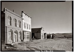 Bodie, California, July 1962. Odd Fellows Hall and Miners Union Hall on Main Street looking north. View full size. Photograph by Ronald Partridge, Historic American Buildings Survey. Bodie, a mining camp ghost town on the eastern slope of the Sierra Nevada between Yosemite and Tahoe, is now a state historic park.