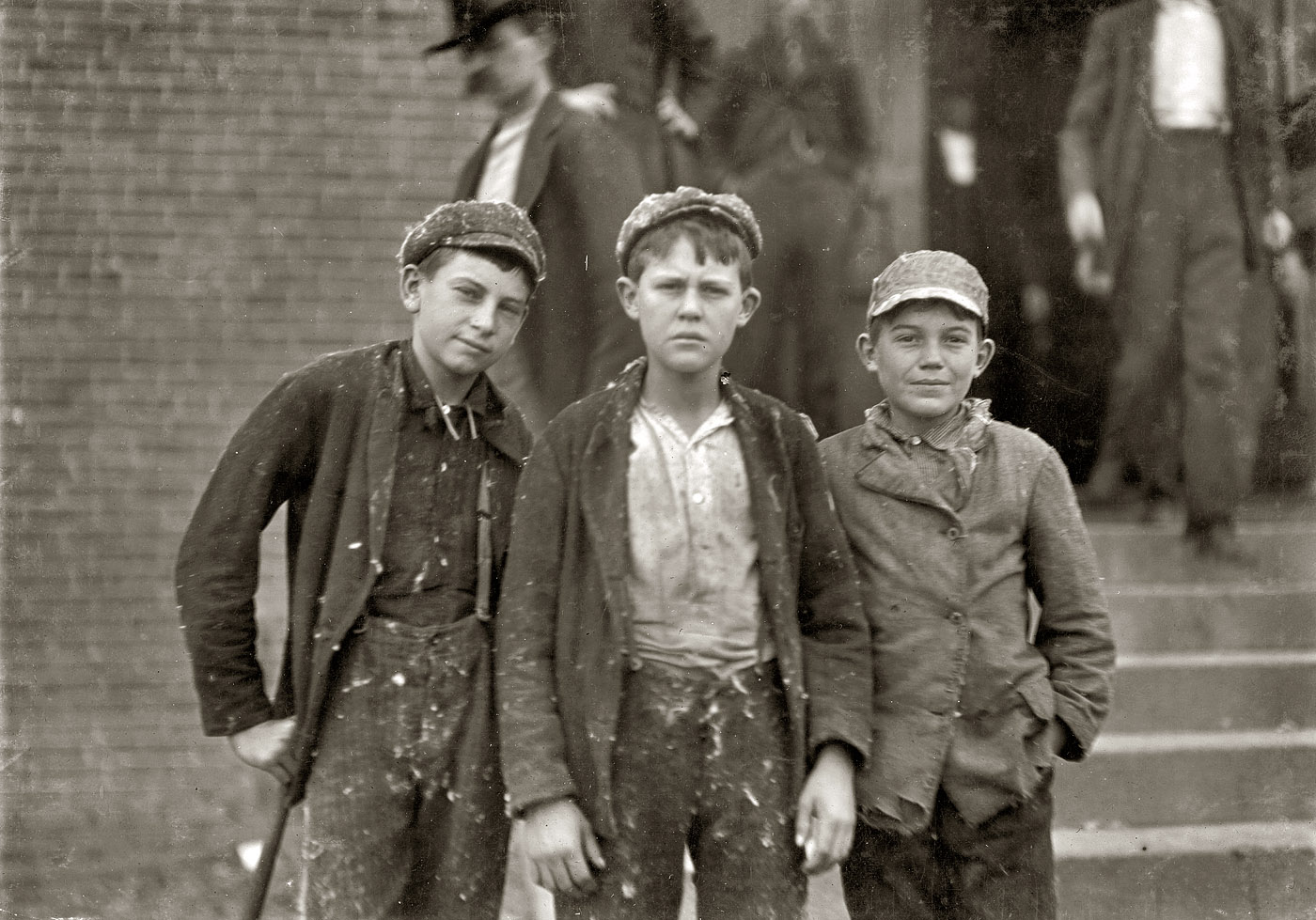 November 1908. Gastonia, North Carolina. "Going home from Loray Mill. Smallest boy on the right-hand end, John Moore. 13 years old. Been in mill 6 years as sweeper, doffer and spinner." Photo by Lewis Wickes Hine. View full size.