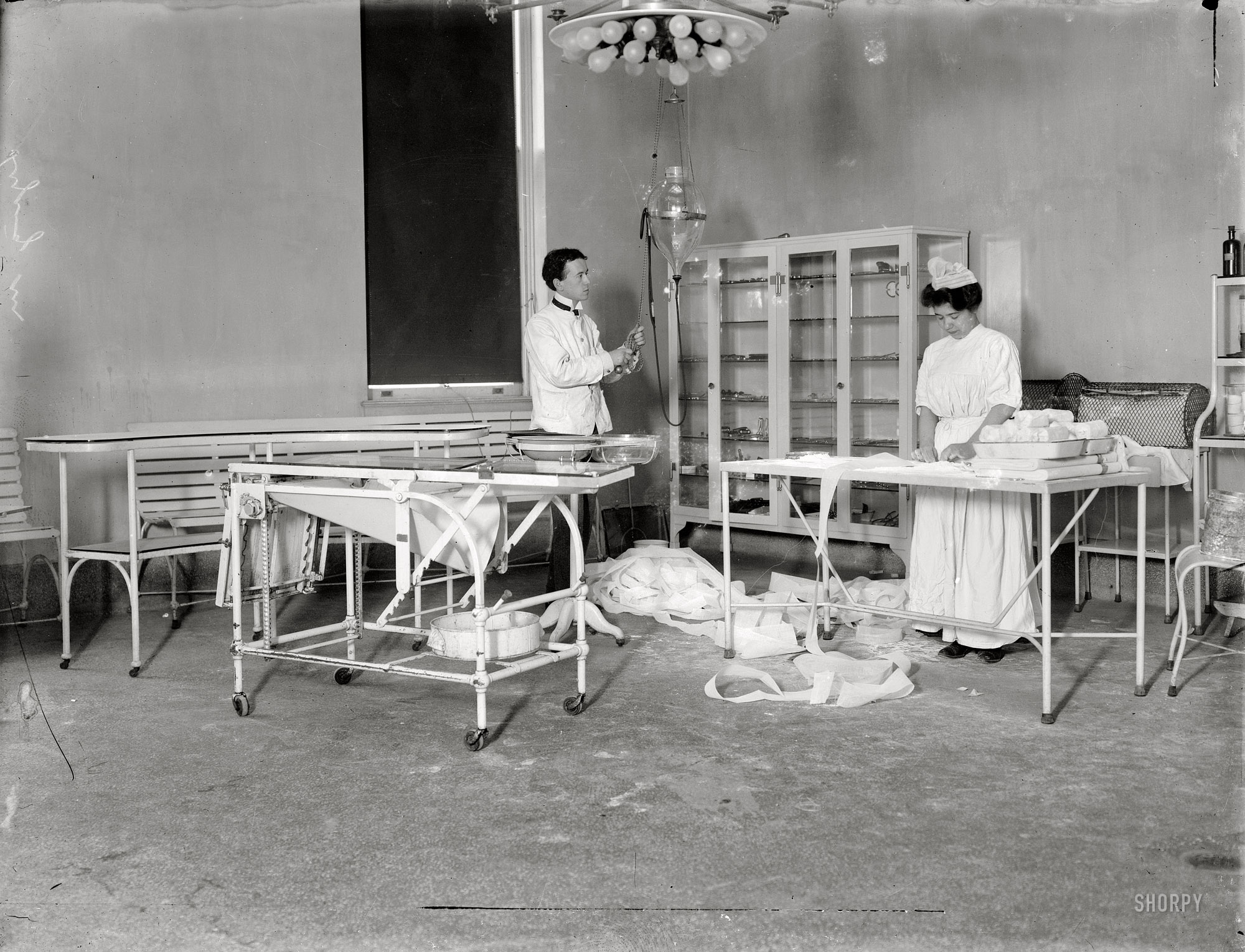 New York circa 1908. "Lying-In Hospital, Second Avenue." A peek behind the scenes at the Lying-In (or maternity) hospital, which in addition to scalpels had a number of cutting-edge medical devices. 8x10 glass negative. View full size.