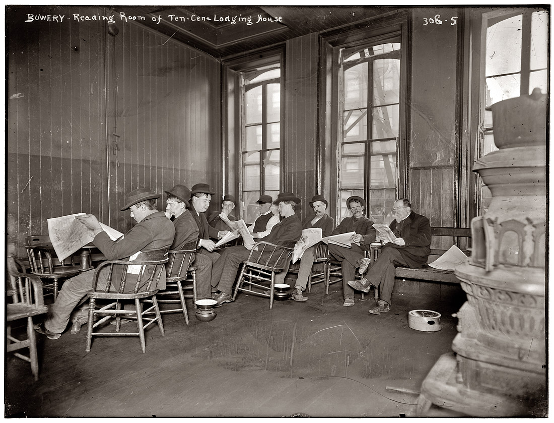 Reading room of 10 cent Bowery lodging house circa 1903. Headline in newspaper: "San Domingo Falls After Big Battle." View full size. 8x10 glass negative, George Grantham Bain Collection.