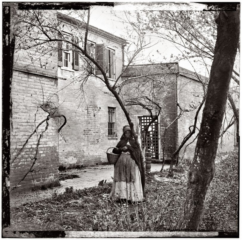 Exterior view of Price, Birch & Co. slave pen at Alexandria, Virginia, circa 1865. Wet collodion, half of glass plate stereograph pair. View full size.