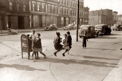 April 1941. Children jumping rope on the sidewalk of a South Side Chicago street. View full size. Printed from a 35mm nitrate negative shot by Russell Lee.