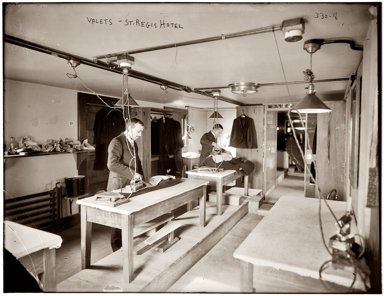 Valets pressing coats with electric irons at the St. Regis Hotel in New York circa 1910. 8x10 glass negative, George Grantham Bain Collection. View full size.