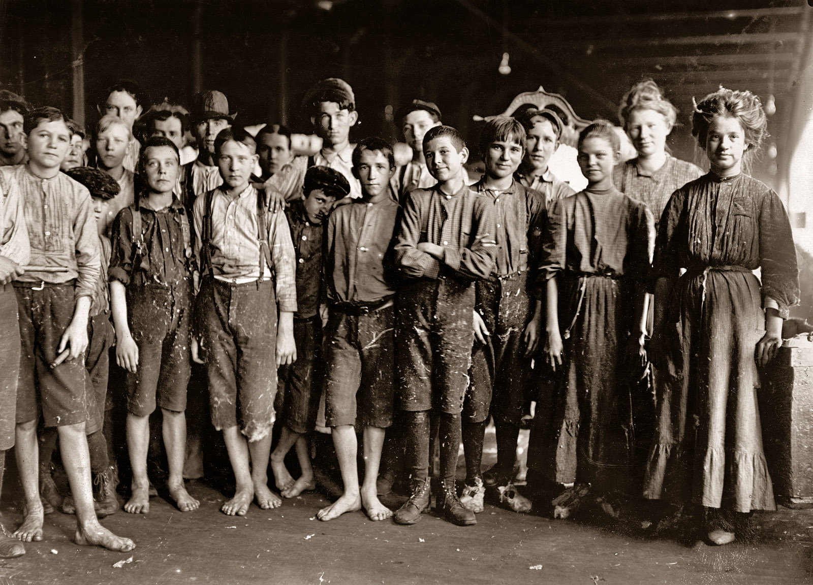 January 1909. Augusta, Georgia. "Noon Hour. Workers in Enterprise Cotton Mill. The wheels are kept running through noon hour (which is only 40 minutes) so employees may be tempted to put in part of this time at machine if they wish." Photograph and caption by Lewis Wickes Hine. View full size.
