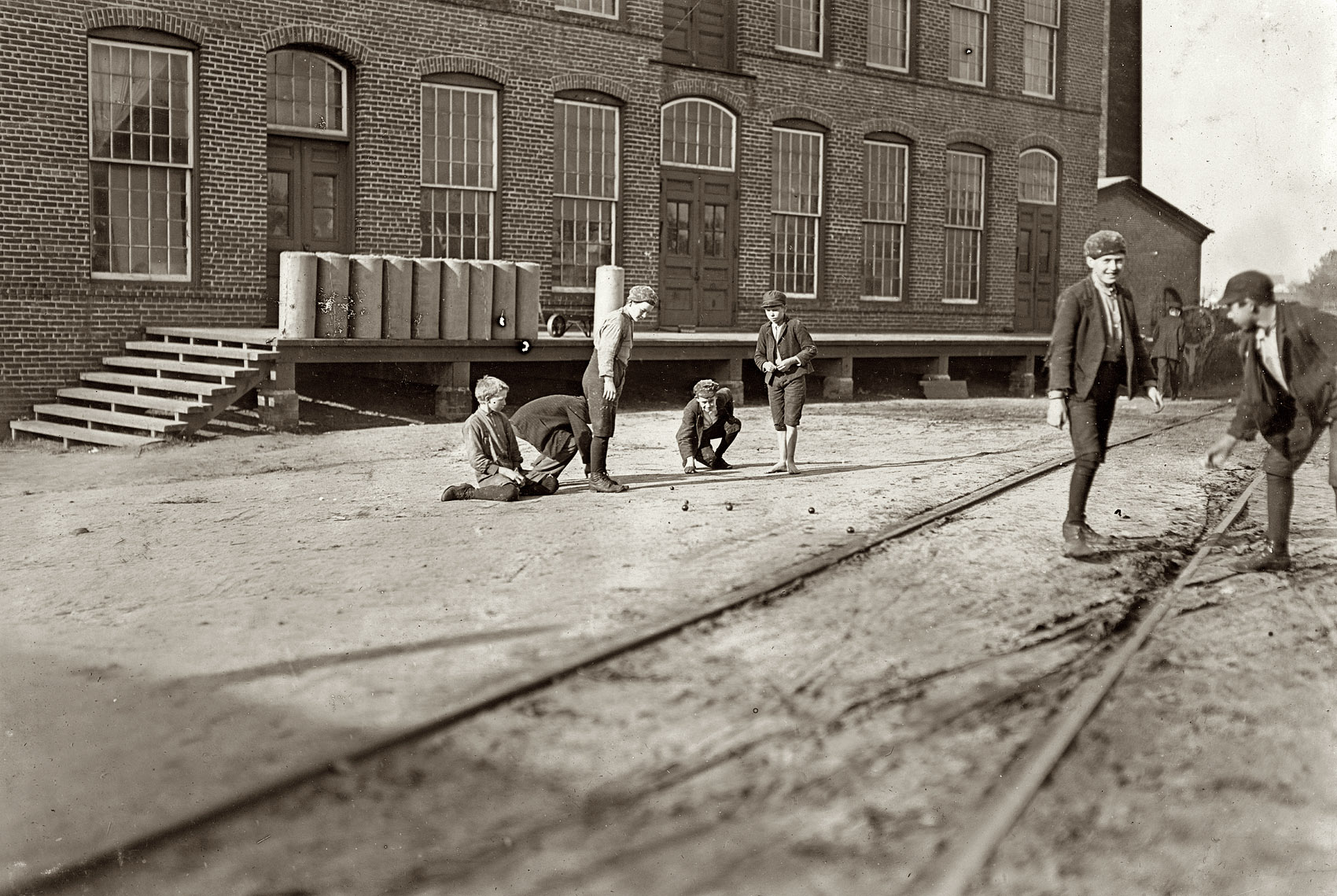 January 1909. Macon, Georgia. "Doffer boys have lots of fun between times. (But get habits of irregular work.) This is the middle of the morning. Willingham Cotton Mills." Photograph and caption by Lewis Wickes Hine. View full size.