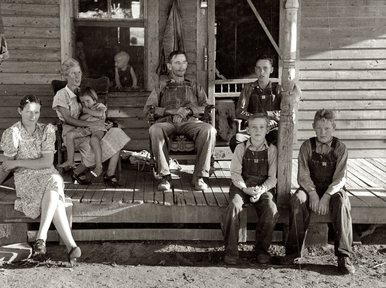 August 1938. "Farm Security Administration client who will become owner- operator under tenant purchase program. Caruthersville, Missouri." This group shot includes the haircut brothers from today's earlier post. 35mm nitrate negative by Russell Lee for the Farm Security Administration. View full size.