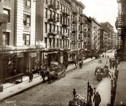 1910. Mott Street in New York's Little Italy, now Chinatown.  At the left, 166 Mott (Raffaele Venezia Cafe) is now Face to Face Skin Care. Google Street View. 8x10 glass negative, George Grantham Bain Collection. View full size.
WatermarkI've noticed the last three pictures have been watermarked. Are you going to be watermarking everything from now on?
[We've always watermarked the really nice ones that are likely to be used elsewhere. They represent hours of labor by yours truly. - Dave]
Really amazing...I love that the buildings have changed barely at all. Really interesting to think of the history in those buildings that the people living there now have probably never considered. 
I Heart NYCWow!  I walked down that street in December when I was visiting NYC (I'm from Brisbane, Australia).  I love the black dog on the right.  Somehow, I always spot the dogs.
Built to LastThe first home I remember was at 1244 15th Avenue in San Francisco. That was 1936. Went past there recently and the street looks exactly the same and it was anything but new when we lived there.
Bet you won't find today's buildings looking exactly the same 100 years from now.  You're doing a wonderful job of teaching/reminding us of our history.  Thank you.
Mott Street, 1925 and todayThis is a fine neighborhood for Dim Sum, and another site immortalized in popular song lyrics, this time in the 1925 Lorenz Hart song "Manhattan":
And tell me what street
Compares with Mott Street
In July?
Sweet pushcarts gently gliding by.
The great big city's a wondrous toy
Just made for a girl and boy.
We'll turn Manhattan
Into an isle of joy.
Thank You Thank YouThanks for the opportunity to see this in a gorgeous and detailed vintage view and in an interesting modern view.  I am a big fan of the "Then and Now" type books on different cities, and love to compare shots such as these.  While I prefer the 1910 photo (if only filmmakers would get this kind of detail in their period-piece movies!), the Google shot has an interest all its own by virtue of one's being able to manipulate the view! Quite amazing, actually.
FantasticWow, I love pictures like this. Not posed at all, just a moment in time caught on film. There are kids playing with something, a guy reading a newspaper, looks like a guy jumping over a broom and every one wearing a hat. The dog, the groceries...perfect. Probably everyone in that picture has already passed on but this one moment in their lives has been captured.
[Very true, although, practically speaking, there was no film back then. This was caught on glass. - Dave]
Time TravelThis is time travel in its purest sense, a view into a moment of time frozen forever.  Italian cafe, shoemakers, street sweeper, horse carts, vegetable vendor, little children moving around in their home neighborhood.  I love it.
Time travel, indeedI recall a time travel novel that had as its basis the fiction that if one were to be so imbued with a time and place and strove to "live" as though you were in that period in a locale that existed now and then, one would wake up some fine day, open the shades and voila, 1910 would be there.  How I wish that were true.  For now I'll just sit here and revel in each detail of pictures such as this.  Thanks again to Dave and all the other posters.
Time and AgainThe time travel novel referred to below was called "Time and Again" and in my opinion is one of the best novels of its kind written. It's also illustrated with old photographs of places that the hero visited. That goes along with my "sliced cheese" theory of time, in which past, present and future exist simultaneously like slices of cheese in a package, and to travel from one era to another all you have to do is figure out how to peel back the paper separating them. Looking at these great, large format photos with all their detail makes me feel like I could really travel back in time if I really concentrated.
[What if time is more like a box of crackers? Or a jar of olives? (The kind with pimentos.) - Dave]
Raffaele Venezia Cafe or Store circa 1910I am looking for info on my friend's ancestor, the above named, who had a shop at 166 and/or 171 Mott Street at the turn of the last century.
Any info appreciated.  
Lynne Funk AIA
LFAArchitects.com
(The Gallery, G.G. Bain, NYC)