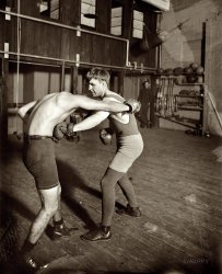 Lightweight boxing champ "Bat" Nelson in 1911. After retiring from the ring, Bat (short for Battling; aka the Durable Dane, born Oscar Nielsen) dabbled in fight promotion and vaudeville. In January 1954, "a pathetic little man of 80 pounds, his mind a complete blank," Bat was committed to the Chicago State Hospital; a month later he was dead of lung cancer at age 71. With 68 wins, 19 draws and 19 losses, Bat once said that although he had "lost several fights," he had never been beaten. 8x10 glass negative, George Grantham Bain Collection. View full size.
The Durable Dane"Bat" was a real brawler, evidently. More here, including great tales and quotes.   
Batty NelsonIt also proves you can only take so many hits before your mind quits. Anyone can brag all they want to about how tough they are but it gets you soon enough. How many of his 71 years were spent in a mindless state? I don't see how anyone could call boxing a sport when the goal was to knock someone senseless. If this Extreme Boxing fad that now exists goes any further we'll see even more of it.
[Bat was put under psychiatric observation in 1927 for stealing a fight film and resisting arrest. He was released after doctors at the Psychopathic Hospital found him to be not insane, just "a trifle eccentric." - Dave]
From the New York Times, 2-26-1927:
CHICAGO, Feb. 25 -- Oscar "Battling" Nelson, the famed "Durable Dane" of Hegewisch, Ill., former world lightweight champion and one of pugilism's outstanding characters, tonight is under psychopathic observation, with a charge of grand larceny hanging over him.
The Dane's greatest ring contest -- his battle seventeen years ago in which he lost the championship to Ad Wolgast -- has risen from fight history to plague him. He faces a charge in Butte, Montana, of stealing the motion pictures of that fight and bringing them here.
Nelson has developed numerous idiosyncrasies since his ring days. He often gesticulates with rights and lefts, his posture while talking often becomes a weaving, swaying motion, like a crafty ringman in battle, and he has eccentricities which, his friends say, may be traced to the terrific punishment he took while battering his way to a world title.
When officers went to Nelson's home to serve the warrant the Dane barricaded himself and surrendered only after some discussion.
When Nelson was taken into court to face extradition proceedings today, his unusual demeanor caught the attention of Judge Max Luster, who ordered him under psychopathic examination.
Battling Nelson vs Eddie LangMy great-uncle Eddie Lang fought Battling Nelson for the title in Nelson's last fight before losing his title to Ad Wolgast in about 40 brutal rounds. My grandfather (father's father) and Eddie's brother was in his corner -- he gave Nelson a scrappy fight and was KO'd in the 8th from body blows. The crowd actually cheered my great-uncle on for mixing it up and the papers called him "The Ghetto Captain." He fought the best around, and his brother Ira Lang (under the name Young Sweeney) did as well -- another great-uncle.
(The Gallery, G.G. Bain, Sports)