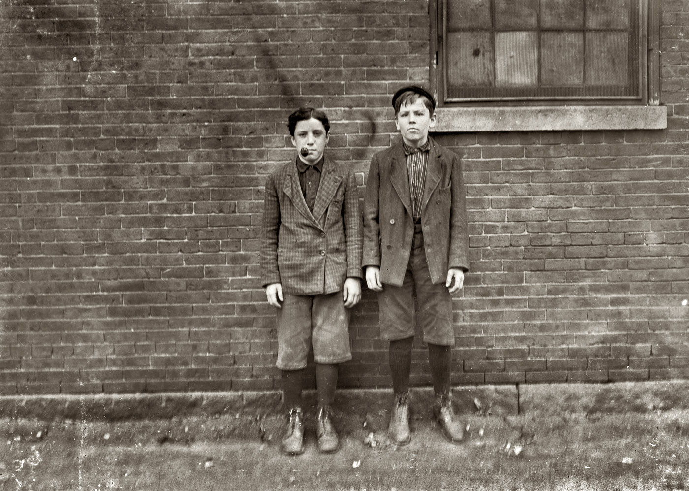 May 1909. Somersworth, New Hampshire. "Lefthand boy Zeke Gosselin, 95 Main Street. Been in mill one year. Other boy Philip Lesard, 68 Elm Street. Been in mill three years. Working in Great Falls Manufacturing Co." View full size.
