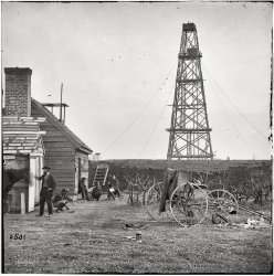 1864. "Bermuda Hundred, Virginia. Photographer [possibly Mathew Brady, next to the horse] at Butler's signal tower, Cobb's Hill, Appomattox River." Note the cloth-draped darkroom and developing chemicals in bottles on the grass. Wet plate glass negative, half of stereo pair. View full size.