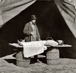 Circa 1861-1865. "Unknown location. Embalming surgeon at work on soldier's body. From photographs of artillery, place and date unknown." Wet plate glass negative, photographer unknown. Library of Congress. View full size.