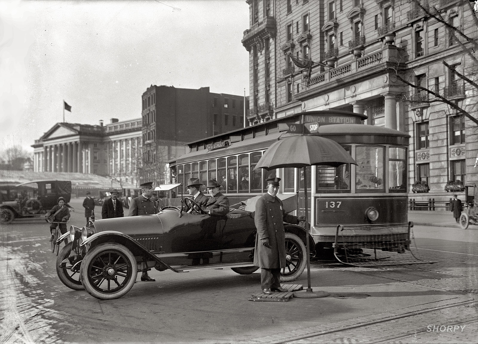 "District of Columbia, 1917. Traffic Stop and Go signs." Traffic safety in Washington with the Treasury building at left. Note the pedestrian-catcher on the streetcar. Harris & Ewing Collection glass negative. View full size.