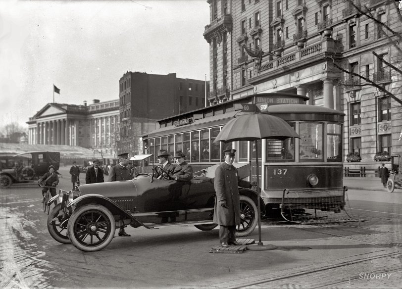 "District of Columbia, 1917. Traffic Stop and Go signs." Traffic safety in Washington with the Treasury building at left. Note the pedestrian-catcher on the streetcar. Harris &amp; Ewing Collection glass negative. View full size.
