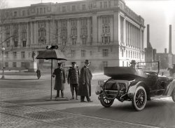 Washington circa 1917. This is, as far as we know, our final glimpse of the Haynes roadster before it motors on its way down 14th Street into eternity. If the darn umbrella ever changes. Harris & Ewing glass negative. View full size.